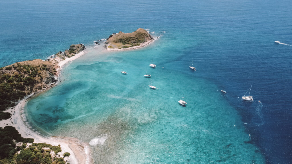 BVI sailing adventures sailboat anchored in turquoise waters at Long Bay Jost Van Dyke British Virgin Islands